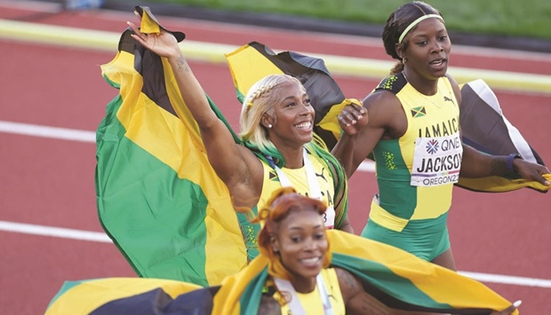 Jamaicau2019s gold-medallist Shelly-Ann Fraser-Pryce (centre), silver-medallist Shericka Jackson (right) and bronze-medallist Elaine  Thompson-Herah celebrate after the womenu2019s 100m final on day three of the World Athletics Championships in Eugene. (Getty Images/AFP)