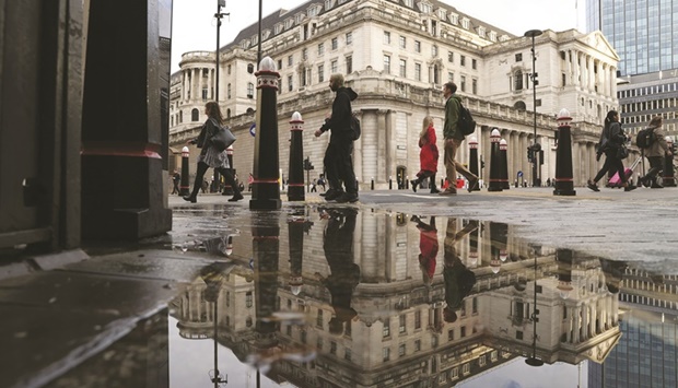 Pedestrians pass the Bank of England in the City of London. The UK government is seeking to avoid a clash with the BoE by playing down the threat of prospective new powers for it to intervene in regulatorsu2019 decisions.
