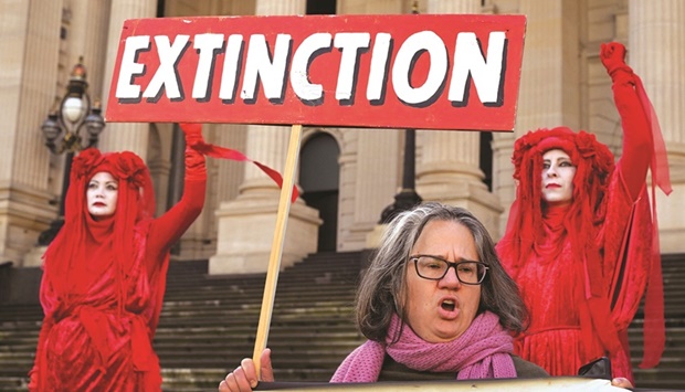 Extinction Rebellion members protest outside the State Parliament of Victoria in Melbourne, yesterday.