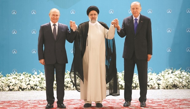Russian President Vladimir Putin, Iranian President Ebrahim Raisi and Turkish President Tayyip Erdogan pose for a picture before a meeting of leaders from the three guarantor states of the Astana process, designed to find a peace settlement to the Syria crisis, in  Tehran, yesterday.