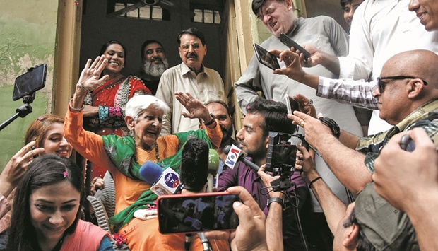 Nonagenarian Reena Varma gestures as she speaks with the members of the media outside her ancestral home in Rawalpindi yesterday. (Reuters)