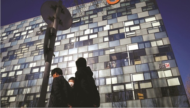 People walk past the headquarters of Didi in Beijing. Chinau2019s cybersecurity regulator yesterday fined Didi $1.2bn, concluding a probe that forced the ride-hailing leader to delist from New York within a year of its debut and made foreign investors wary about Chinau2019s tech sector.