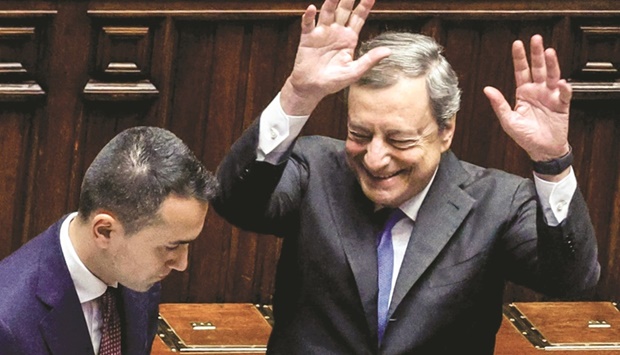 Draghi acknowledges applause upon his arrival at parliament in Rome. Also seen is Foreign Minister Luigi de Maio.