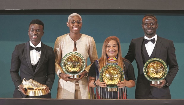 Bayern Munichu2019s Sadio Mane (right) poses after winning the African Footballer of the Year award alongside the womenu2019s player of the year Asisat Oshoala (second left) and other award winners in Rabat, Morocco, on Thursday. (Reuters)
