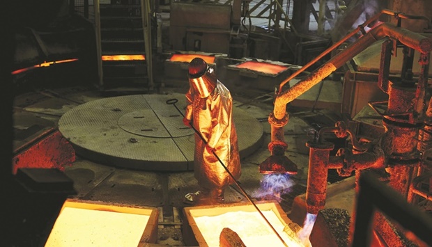 A worker in heat resistant protective clothing supervises the liquid copper mould production line at the KGHM Polska Miedz smelting plant in Glogow, Poland. Energy crises and central bank moves to crush inflation present powerful headwinds across markets, underscored by copperu2019s collapse on Friday below $8,000 a tonne.