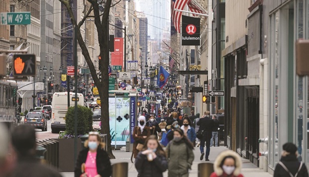 People walk on a busy 5th Avenue in midtown Manhattan. Reports showed business activity unexpectedly contracting across the US and euro-area for the first time in more than two years.