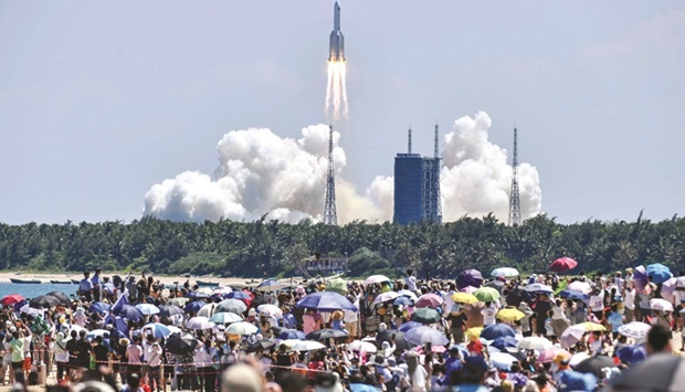 Onlookers watch the launch of a rocket transporting Chinau2019s second module for its Tiangong space station from the Wenchang spaceport in southern China.