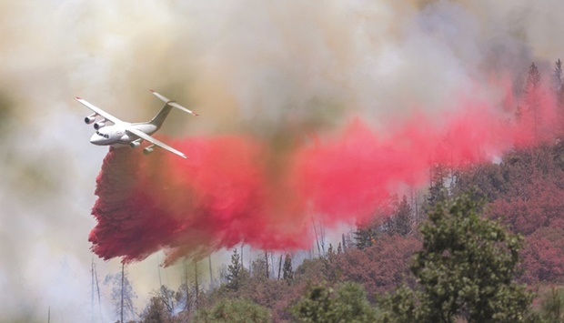 Air Tanker 162 makes a fire retardant drop at the Oak Fire near Mariposa, California.