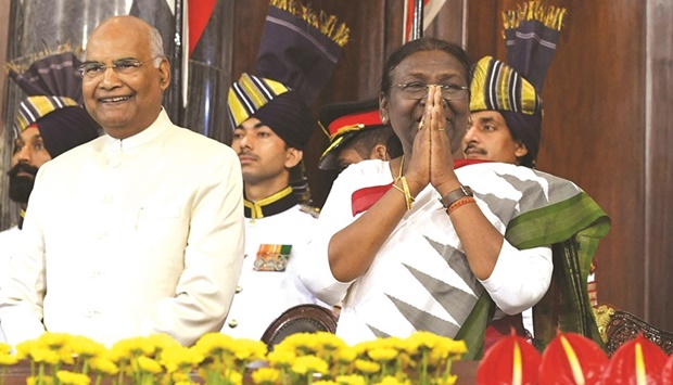 This handout photograph released by Indiau2019s Presidential Palace Rashtrapati Bhavan shows Indiau2019s new President Droupadi Murmu during her swearing-in ceremony in the central hall of the parliament in New Delhi. On the left is her predecessor Ram Nath Kovind.