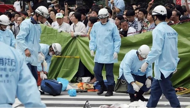 This file photo taken on June 8, 2008 shows rescue workers gathering at the site where a man went on a stabbing spree in Tokyo's Akihabara electronic shops street.