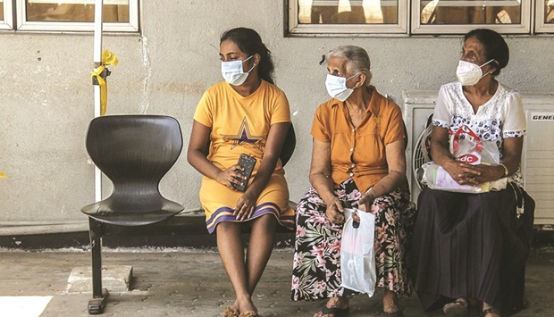 Patients wait for their appointment with medical staff outside a ward at the National Hospital in Colombo.