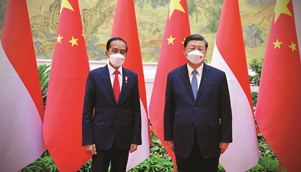 This handout photo taken and released yesterday shows Indonesiau2019s President Joko Widodo and Chinau2019s President Xi Jinping posing for a photograph prior to a meeting in Beijing.