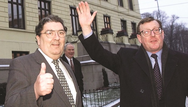 John Hume gives the thumbs up as fellow David Trimble waves as they leave the Nobel Institute in Oslo on December 9, 1998. They were in Norway to receive their joint 1998 Nobel Peace Prize for their efforts to find a peaceful solution to the conflict in Northern Ireland.