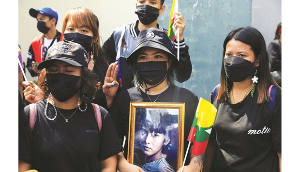 Myanmar citizens who live in Thailand, hold a portrait of former state counsellor Aung San Suu Kyi as they protest against the execution of pro-democracy activists, at Myanmar embassy in Bangkok, yesterday.