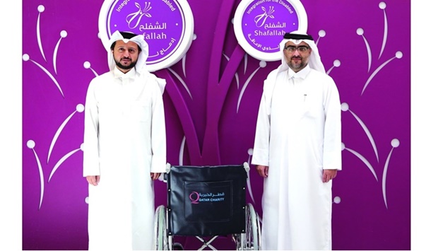 Dr Mohamed Talfat and Farid Khalil al-Siddiqi during the handing over of wheelchairs.