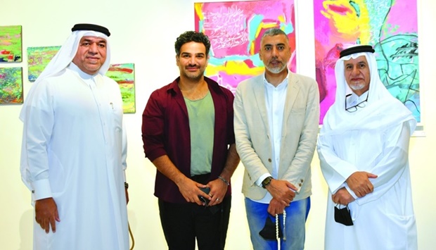 Fire Station director Khalifa al-Obaidli (left) and Qatari artist Hassan al-Mulla (right) with other participating artists at the opening of the two exhibitions Wednesday. PICTURES: Thajudheen