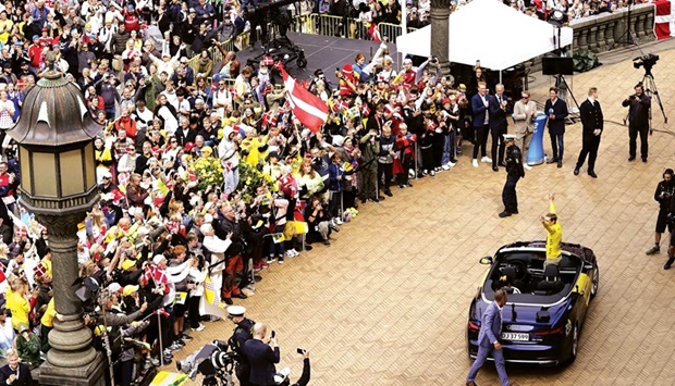 Jumbo-Visma teamu2019s Danish rider Jonas Vingegaard, winner of the 2022 Tour de France, cheers towards a crowd of supporters at the town hall square in Copenhagen yesterday. (AFP)