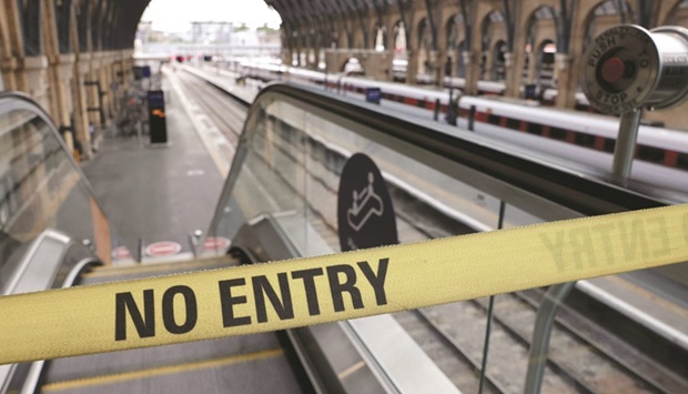 A u201cNo Entryu201d belt barrier blocks access to a platform at Kingu2019s Cross railway station in London yesterday. (AFP)