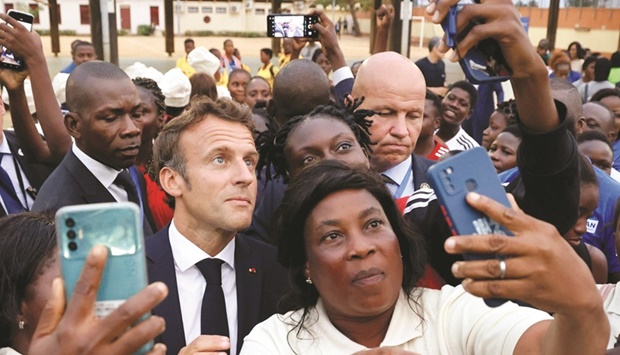 Franceu2019s President Emmanuel Macron poses for selfies with sportswomen during his visit to the French College (Lycee) in Cotonou, yesterday.