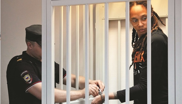 A policeman removes the handcuffs from two-time Olympic gold medallist Brittney Griner in a courtroom prior to a hearing, in Khimki, outside Moscow yesterday. American basketball star Brittney Griner returned to a Russian courtroom for her drawn-out trial on drug charges that could bring her 10 years in prison if convicted. (Reuters)