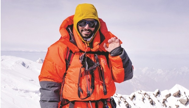 Fahad Badar displays on top of Mount K2 his left hand which lost four fingers in a climbing accident in October 2021.
