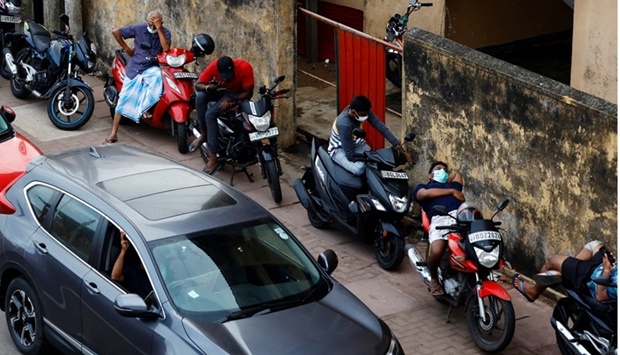 Riders wait in a line to buy petrol from a fuel station, amid Sri Lanka's economic crisis, in Colombo, Sri Lanka. REUTERS