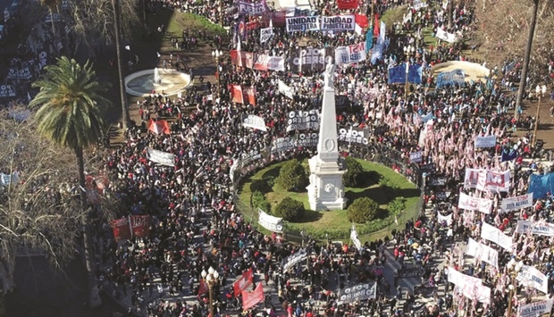Unemployed and informal workers gather outside the presidential palace in Buenos Aires during a protest.