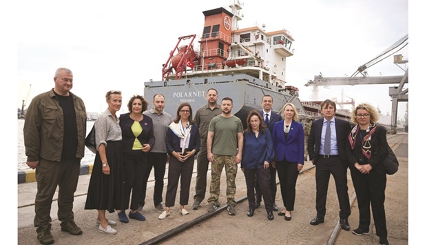 This handout picture taken and released by Ukrainian Presidential Press Service yesterday shows the President Volodymyr Zelensky posing for a picture with western ambassadors and Ukrainian officials, in front of the Turkish cargo ship u2018Polarnetu2019, during a visit to Black Sea port of Chornomorsk. Zelensky visits the southern port of Chornomorsk ahead of the first anticipated export of grain under a deal with Russia.