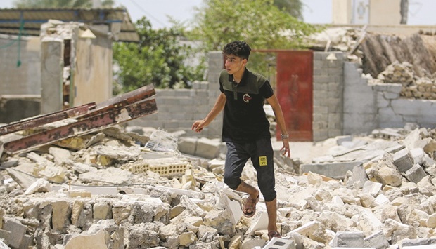 An Iranian man walks amid the rubble after an earthquake in Sayeh Khosh village in  Hormozgan, yesterday.