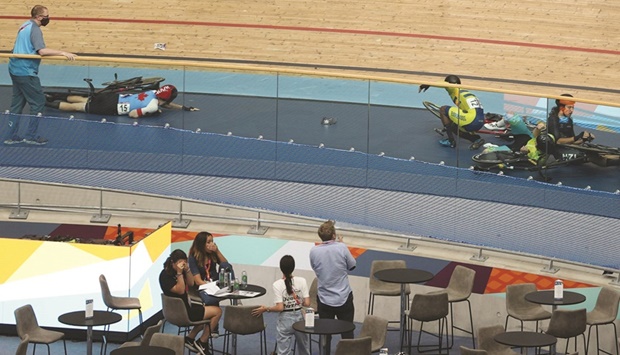 People react to a massive crash during the menu2019s 15km scratch race qualifying round cycling event on day three of the  Commonwealth Games, at the Lee Valley VeloPark in east London, yesterday. (AFP)