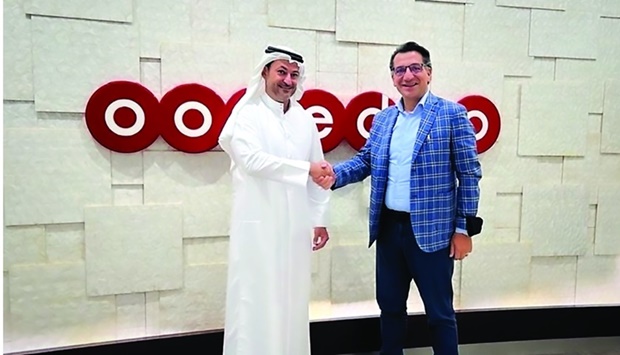 Aziz Aluthman Fakhroo, managing director and Group CEO, Ooredoo, shaking hands with Matteo Gatta, CEO of BICS.