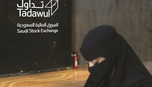 A woman walks at the Saudi Stock Exchange (Tadawul) in Riyadh (file). Saudi Arabian stocks briefly erased this yearu2019s gains in June and are down more than 16% from highs in May.