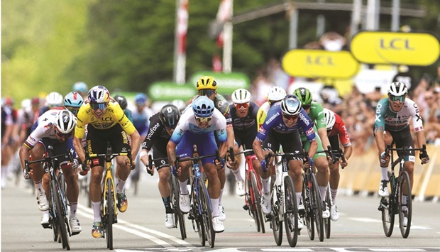 Team Bikeexchange-Jayco teamu2019s Dutch rider Dylan Groenewegen (second right) sprints flanked by Jumbo-Visma teamu2019s Belgian rider Wout Van Aert (second left),  Totalenergies teamu2019s Slovakian rider Peter Sagan (left) and  Alpecin-Deceuninck teamu2019s Belgian rider Jasper Philipsen (right) as they crosses to the finish line of the 3rd stage of the 109th edition of the Tour de France cycling race, 182km between Vejle and Sonderborg in Denmark, yesterday. (AFP)