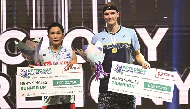 Denmarku2019s Viktor Axelsen (right) poses with his gold medal next to silver medallist Japanu2019s Kento Momota after the singles final at the Malaysia Open in Kuala Lumpur yesterday. (AFP)