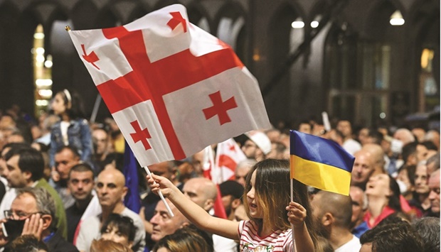 A girl waves Georgian and Ukrainian national flags during a rally in support of Georgiau2019s membership to the European Union in Tbilisi yesterday. (AFP)