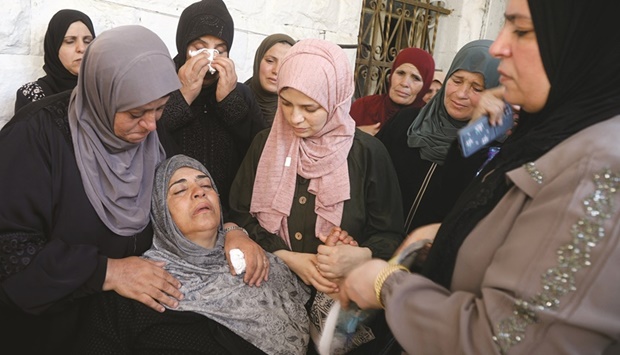 Mourners help deceasedu2019s mother during a funeral of Kamel Alawneh, who succumbed to wounds sustained during an Israeli raid, in Jenin in the occupied West Bank, yesterday.