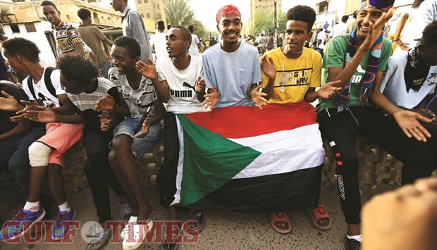 Protesters shout slogans during a sit-in rally against military rule following the last coup and to commemorate the third anniversary of demonstrations in Khartoum, yesterday.