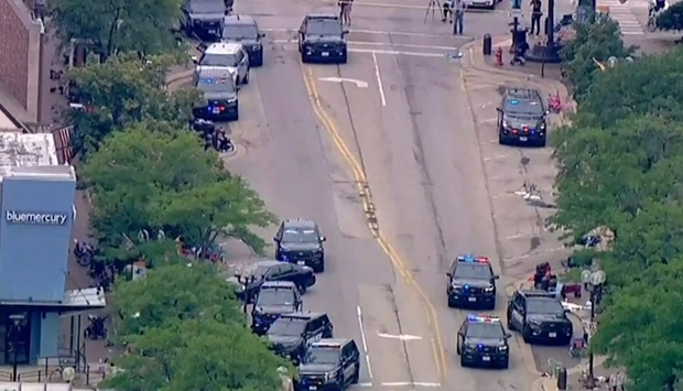 Police deploy after gunfire erupted at a Fourth of July parade route in the wealthy Chicago suburb of Highland Park, Illinois,  in a still image from video. ABC affiliate WLS/ABC7 via REUTERS