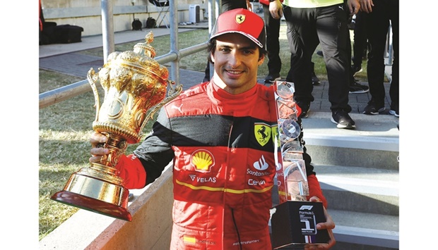 Ferrariu2019s Carlos Sainz Jr. celebrates with his trophies after winning the British Grand Prix at Silverstone Circuit on Sunday. It was the 27-year-old Spaniardu2019s first career win on his 150th career start in F1. (Reuters)
