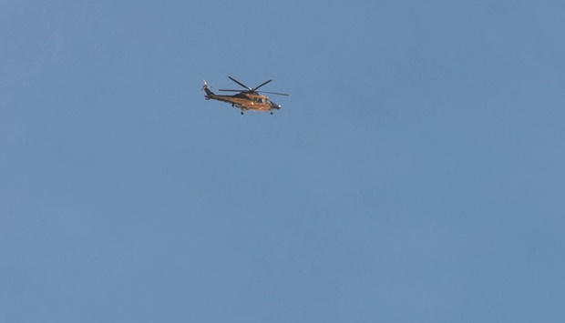 A u201cGuardia di Finanziau201d helicopter flies above the Marmolada glacier, near Canazei yesterday. (AFP)