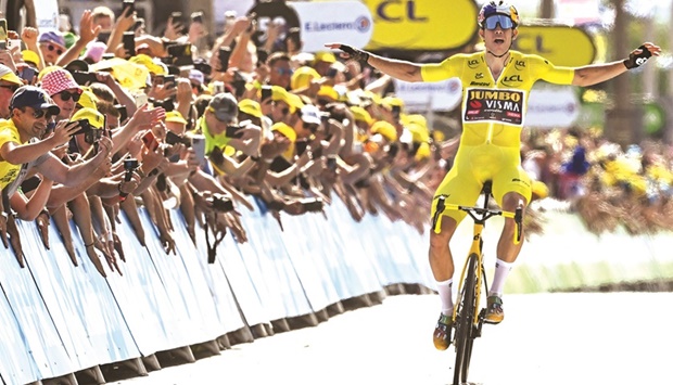 Jumbo-Visma teamu2019s Belgian rider Wout Van Aert celebrates as he cycles past the finish line to win the 4th stage of the 109th edition of the Tour de France cycling race, 171.5km between Dunkirk and Calais, in northern France, yesterday. (AFP)