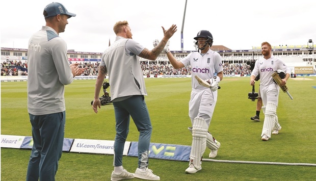 Englandu2019s Joe Root (second right) and Ben Stokes (second left) celebrate after winning the Test against India at Edgbaston in Birmingham yesterday. Also seen are Jonny Bairstow (right) and James Anderson. (Reuters)