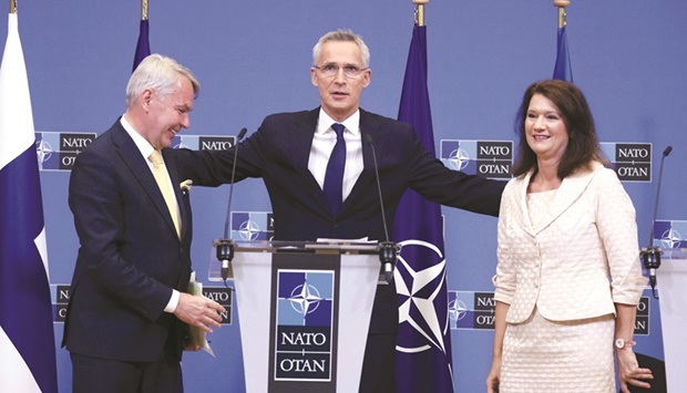 Nato Secretary-General Jens Stoltenberg (centre) embraces Finnish Foreign Minister Pekka Haavisto (left) and Swedish Ministry for Foreign Affairs Ann Linde after the signing of the accession protocols of Finland and Sweden at the Nato headquarters in Brussels yesterday. (AFP)