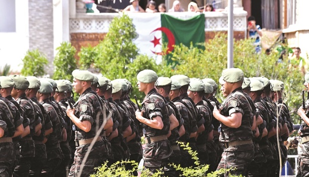 Algerian soldiers parade down a street in the capital Algiers.
