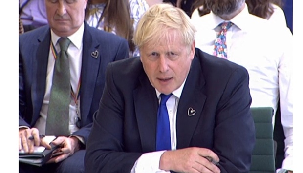 A video grab from footage broadcast by the UK Parliament's Parliamentary Recording Unit (PRU) shows Britain's Prime Minister Boris Johnson answering questions at a parliamentary Liaison Committee hearing in the House of Commons in London on July 6, 2022. AFP/PKU