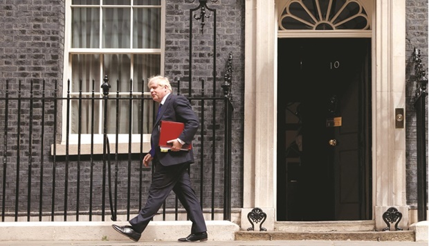 British Prime Minister Boris Johnson walks outside 10 Downing Street in London yesterday. (Reuters)