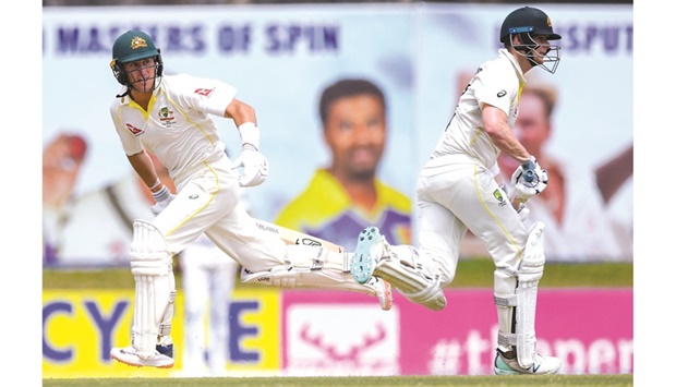 Australiau2019s Marnus Labuschagne (left) and Steve Smith run between the wickets during the first day of second Test against Sri Lanka at the Galle International Cricket Stadium in Galle yesterday. (AFP)