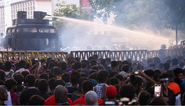 Police use a water canon to disperse demonstrators taking part in an anti-government protest demanding the resignation of Sri Lanka's President Gotabaya Rajapaksa over the country's crippling economic crisis, in Colombo on July 8, 2022. 