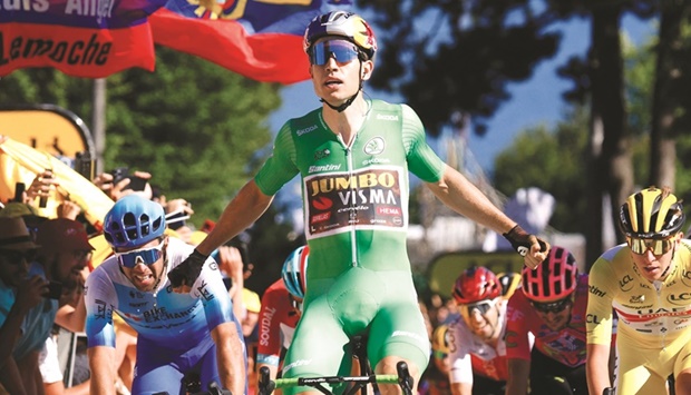 Vismau2019s Wout Van Aert  celebrates as he crosses the finish line to win stage 8 of the Tour de France in Lausanne, Switzerland, yesterday. (Reuters)
