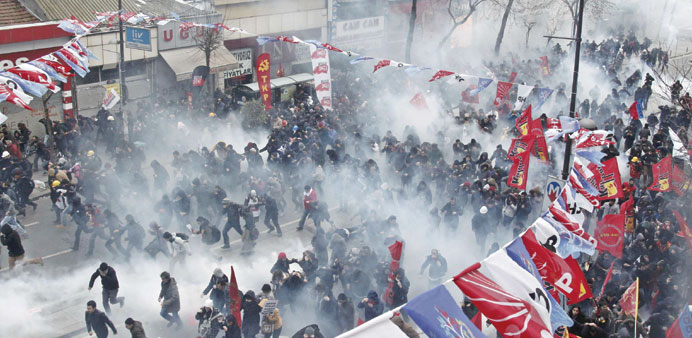    Anti-government protesters run as riot police fire tear gas during a demonstration in Istanbul yesterday.